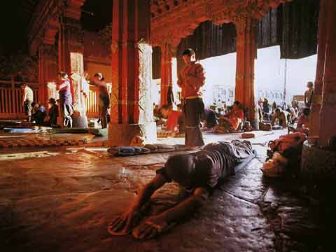 
Pilgrims Prostrating At Jokhang Temple In Lhasa - Buddhism: Eight Steps To Happiness by Dieter Glogowski book
